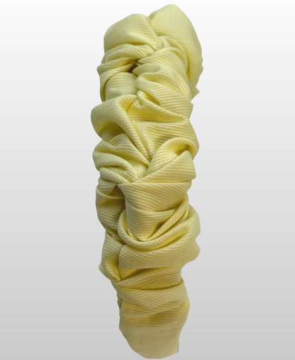 Serre-tête froncé jaune pastel.