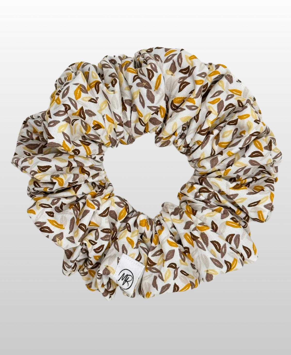 Chouchou en popeline de coton au motif végétal poétique.
